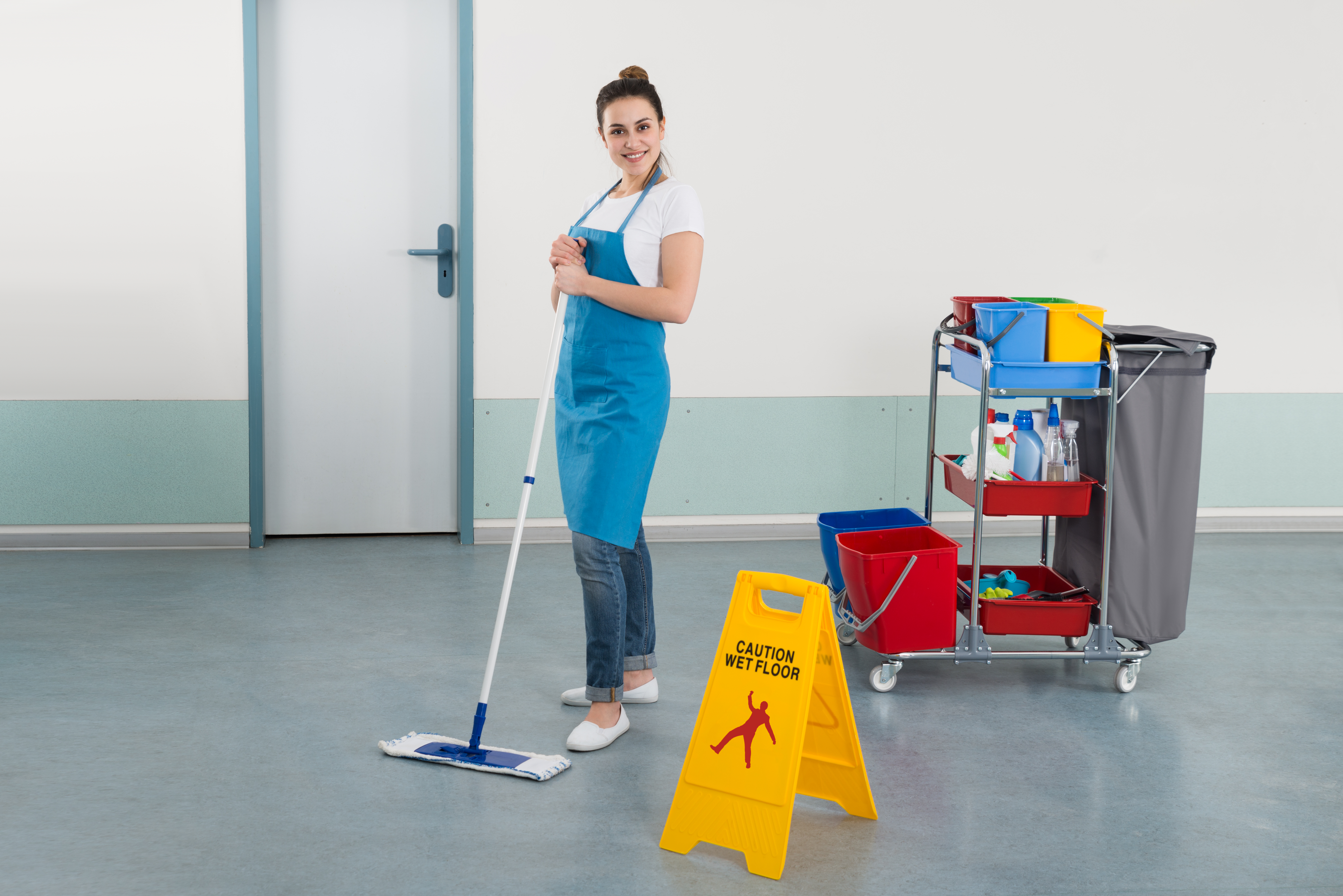 Female Janitor Mopping Corridor